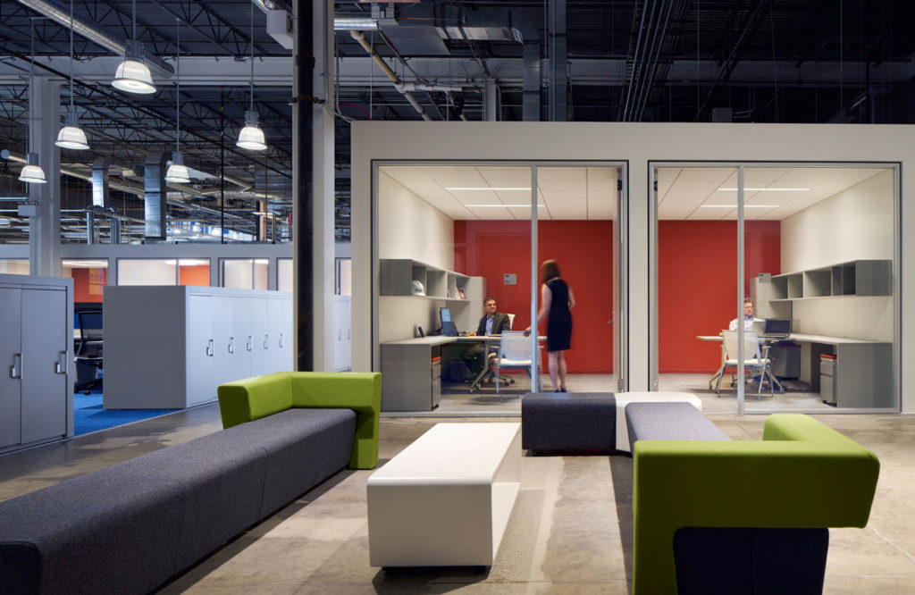 UI Labs by SOM, glass-walled offices with red accent walls and green lounge seating in a converted industrial space, Chicago