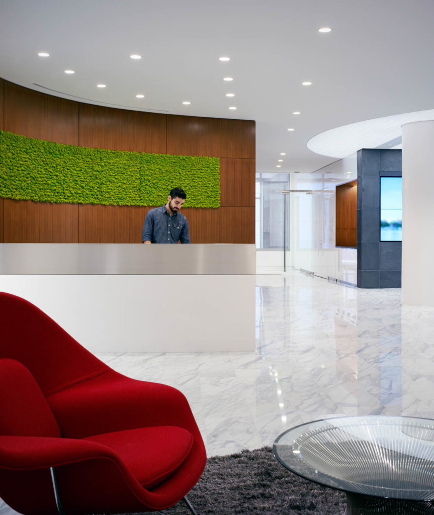 ABC DC by SmithGroup, lobby with a red lounge chair, marble floor and a living moss wall, Washington
