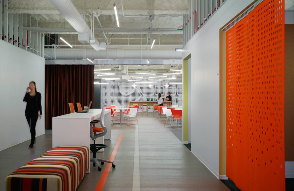 Discover Offices by Gensler, corridor with an orange perforated screen and a striped bench, Chicago
