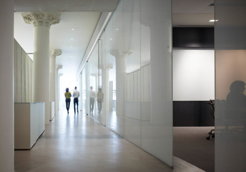Gensler Chicago Office by Gensler, glass-lined corridor between historic columns, Chicago