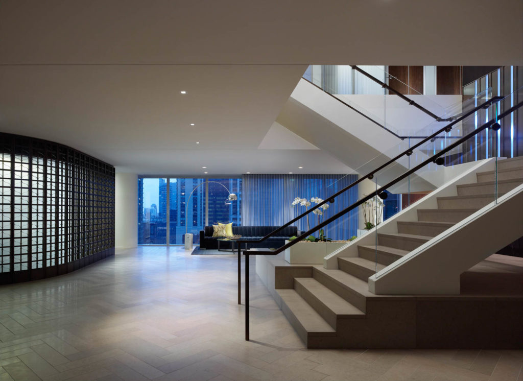 Spencer Stuart by Gensler, reception with a sculptural stair and city views, Chicago