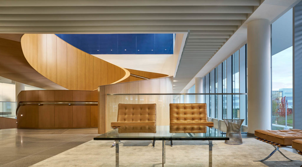 Roche Diagnostics North American Headquarters by CannonDesign, lounge with leather daybeds beneath a curving wood ceiling and blue skylight, Indianapolis