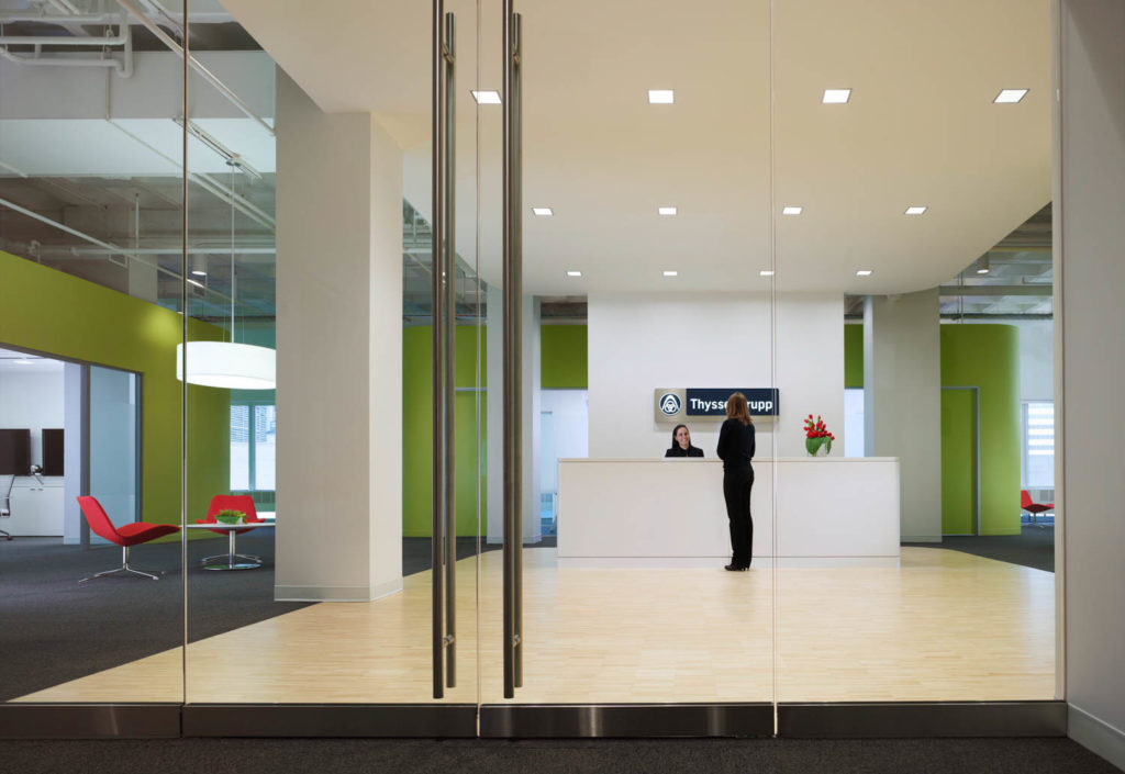 ThyssenKrupp by HED, reception framed by glass doors and lime green walls, Chicago