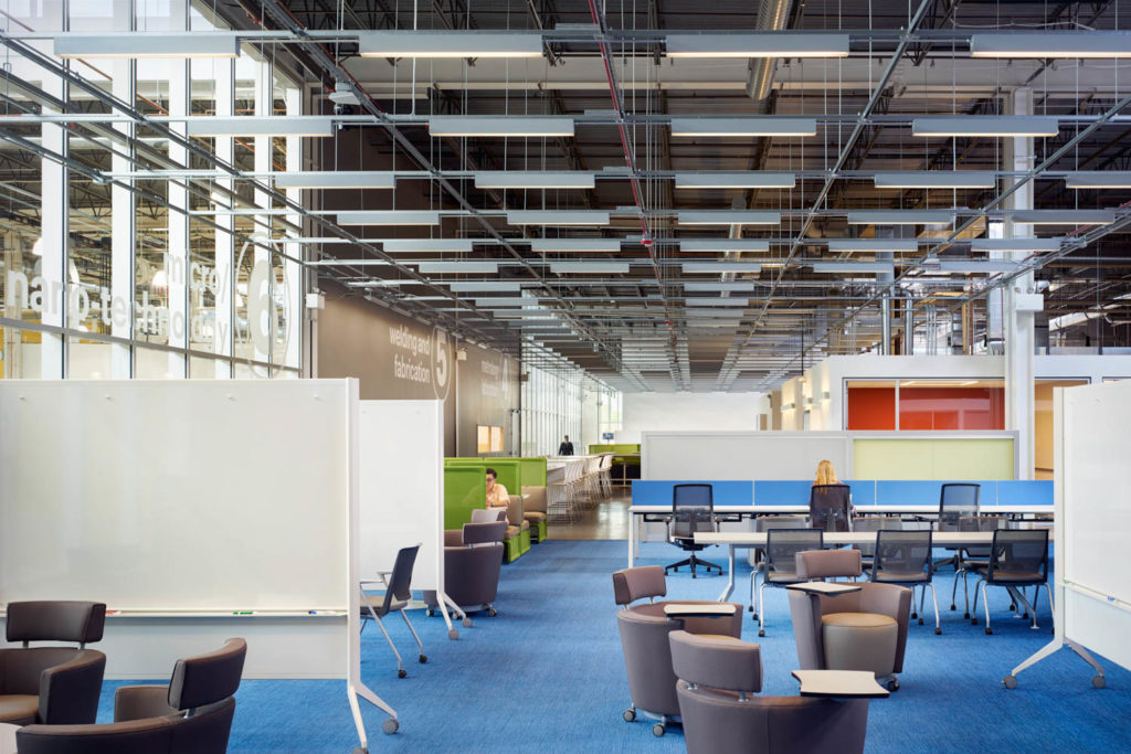 UI Labs by SOM, open workspace with blue carpet beneath an exposed ceiling, Chicago