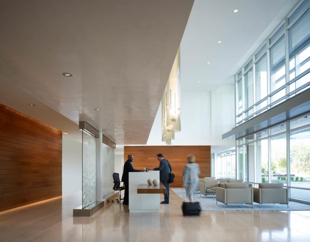 Quintiles by Gensler, reception with a wood wall and a glass water feature, Virginia