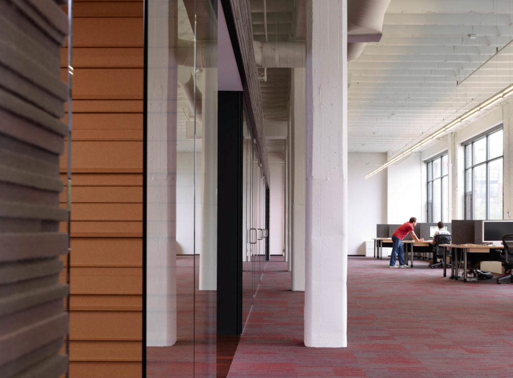 37signals by Brininstool + Lynch, wood-clad meeting rooms along an open loft workspace, Chicago