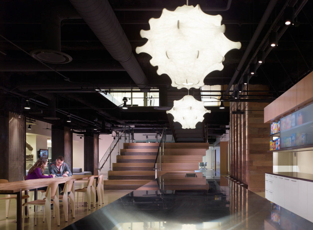 Chicago Trading Company by Gensler, communal table and stair beneath paper pendant lights, Chicago