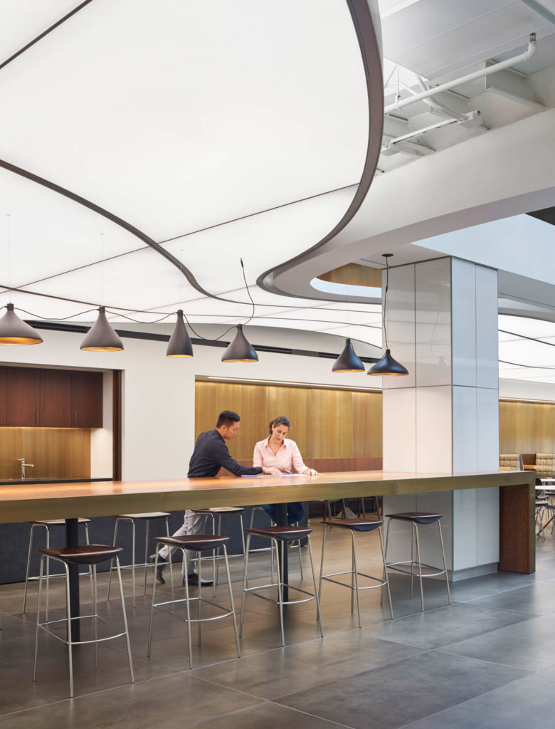 Amenity space by CannonDesign, coffee bar with pendant lights beneath a curving white ceiling, Chicago