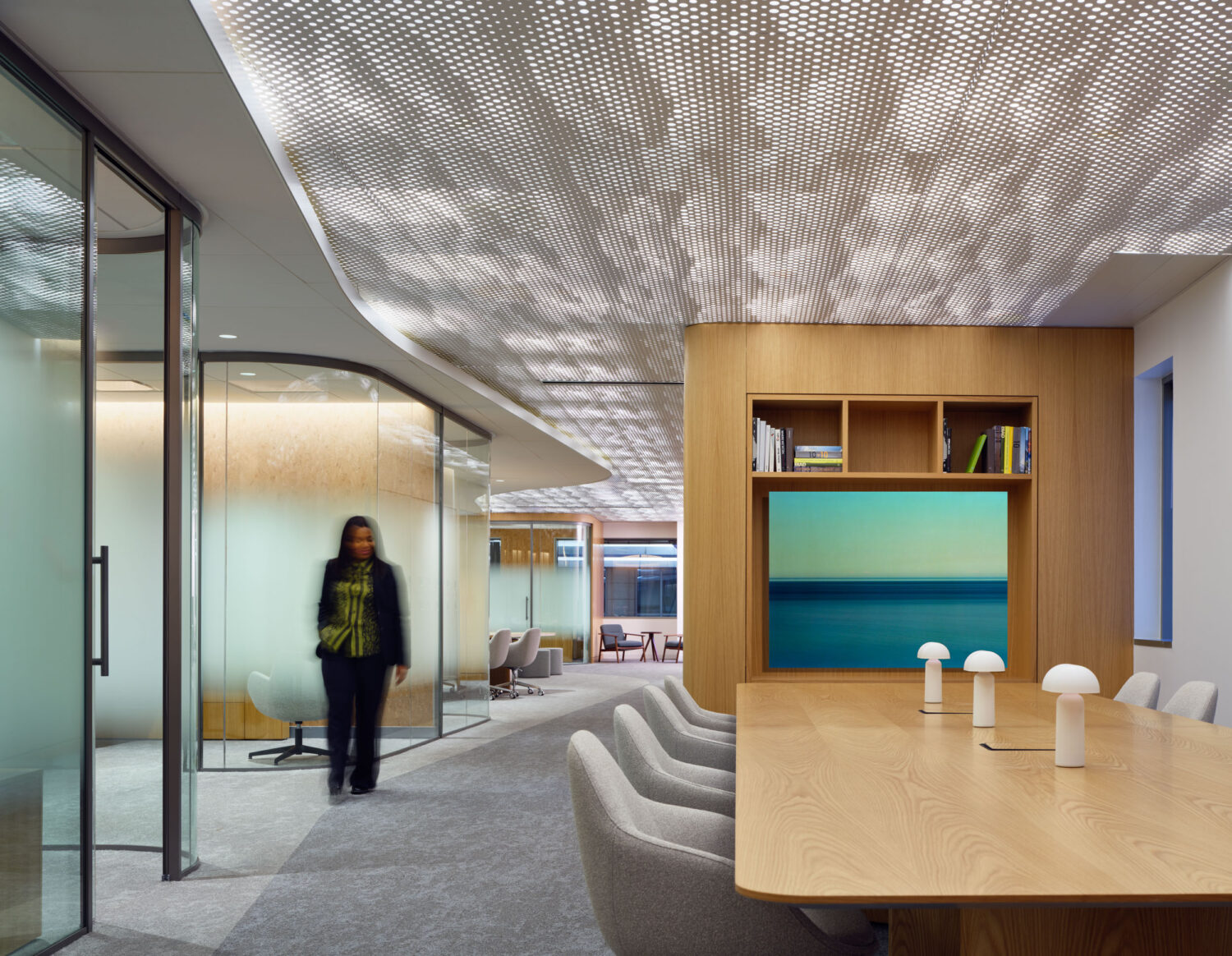 Meeting area at the Northwestern Medicine Faculty Office Center by CannonDesign with wood walls and a sculpted metal ceiling