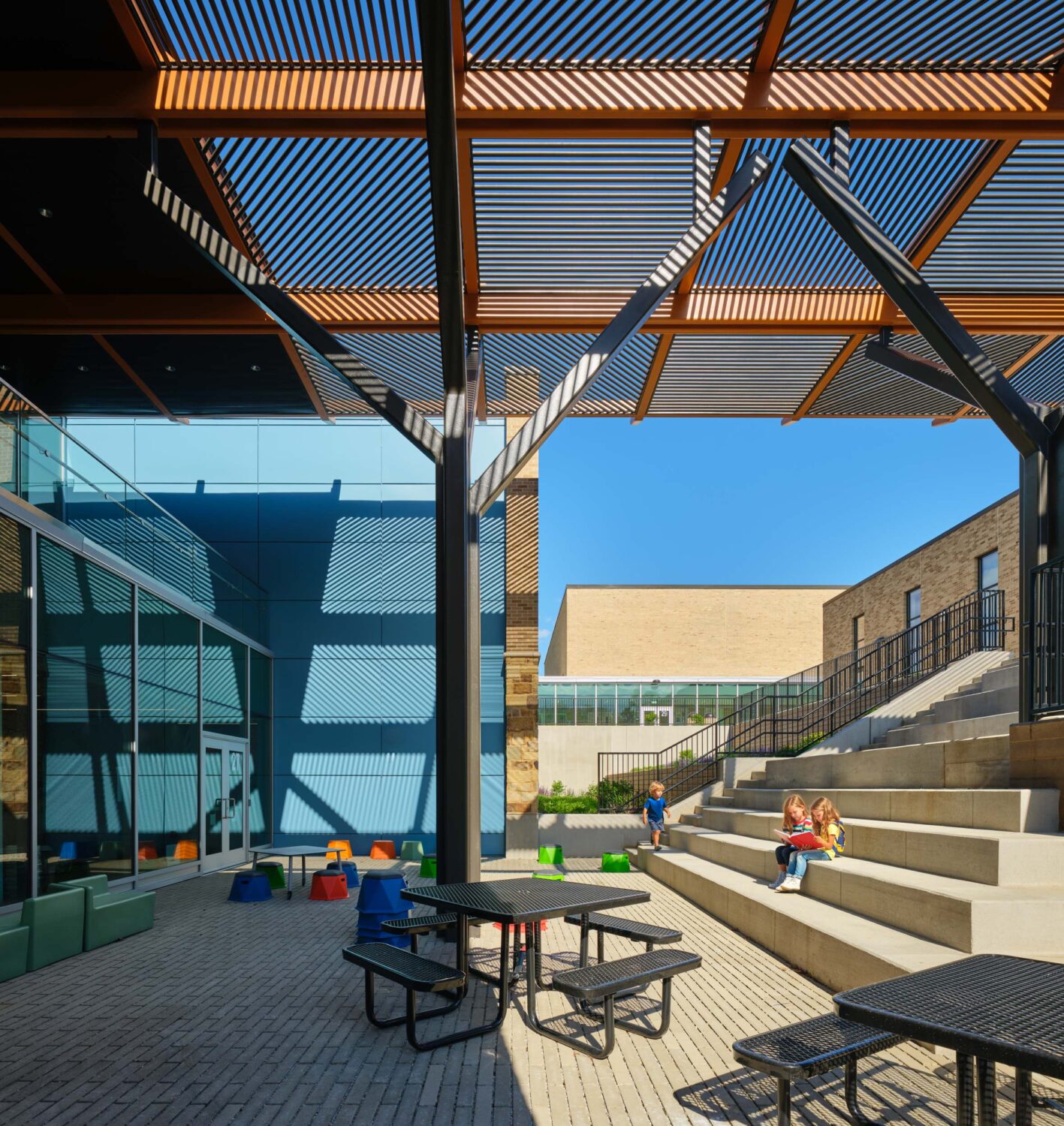 Outdoor learning steps under a timber canopy at the Glen Ellyn kindergarten by Wight & Company