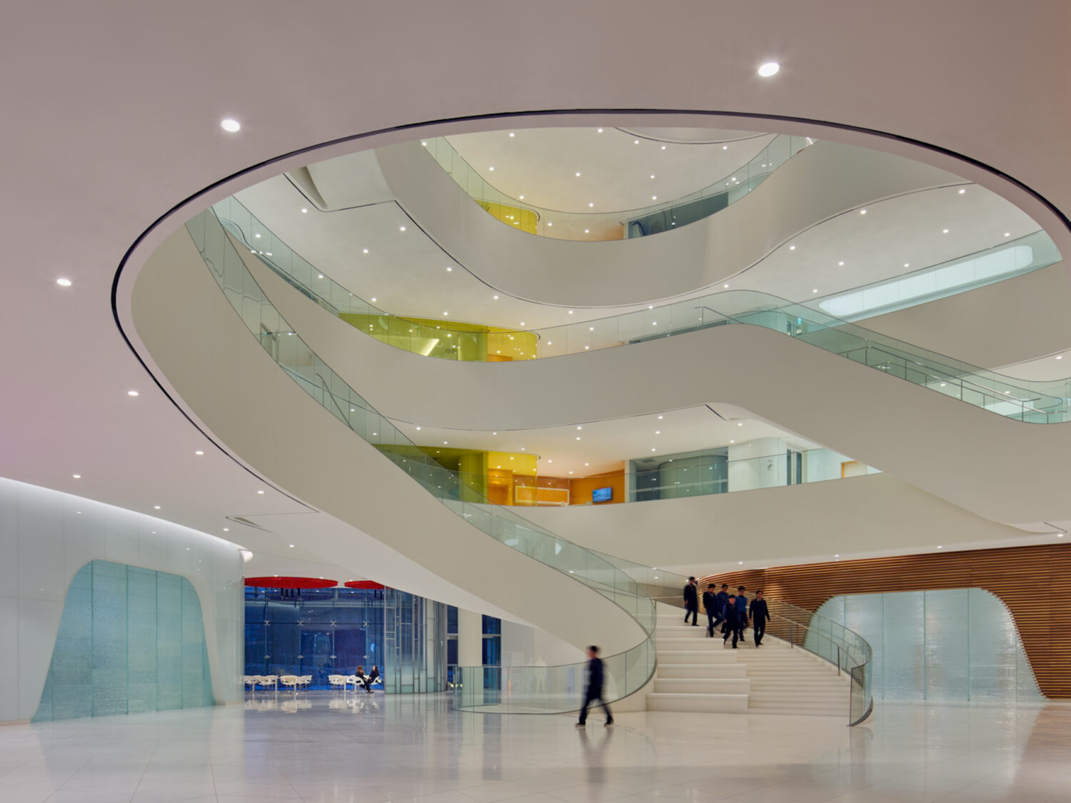 Sweeping white spiral balconies and stair rising through the atrium of CJ Blossom Park