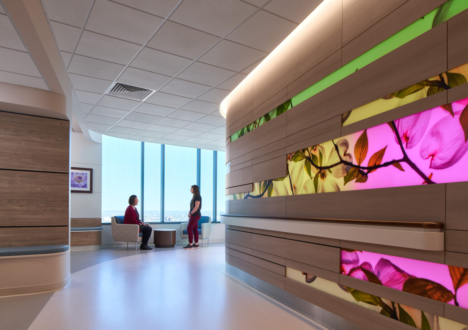 Waiting area with backlit floral wall panels and city views, Cambridge Tower A, The University of Kansas Health System by CannonDesign, Kansas City, Kansas