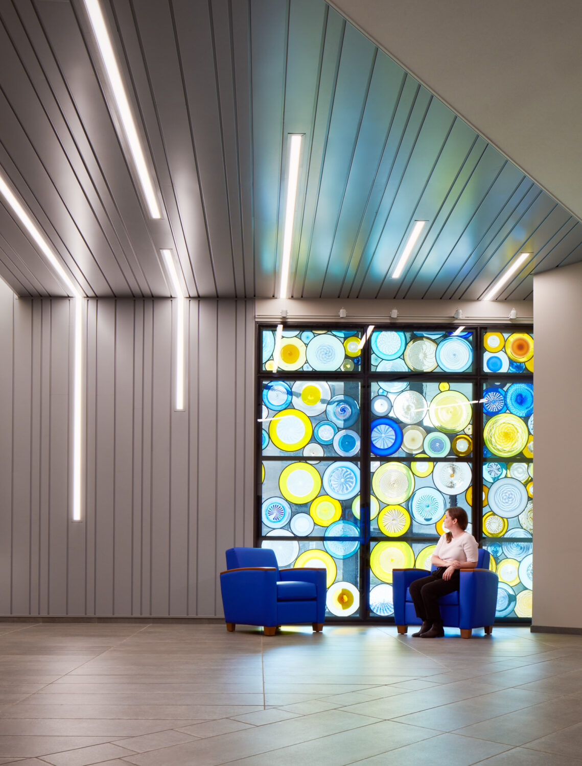 Seating area beside a colorful stained glass window, University Health Truman Medical Center by CannonDesign, Kansas City, Missouri