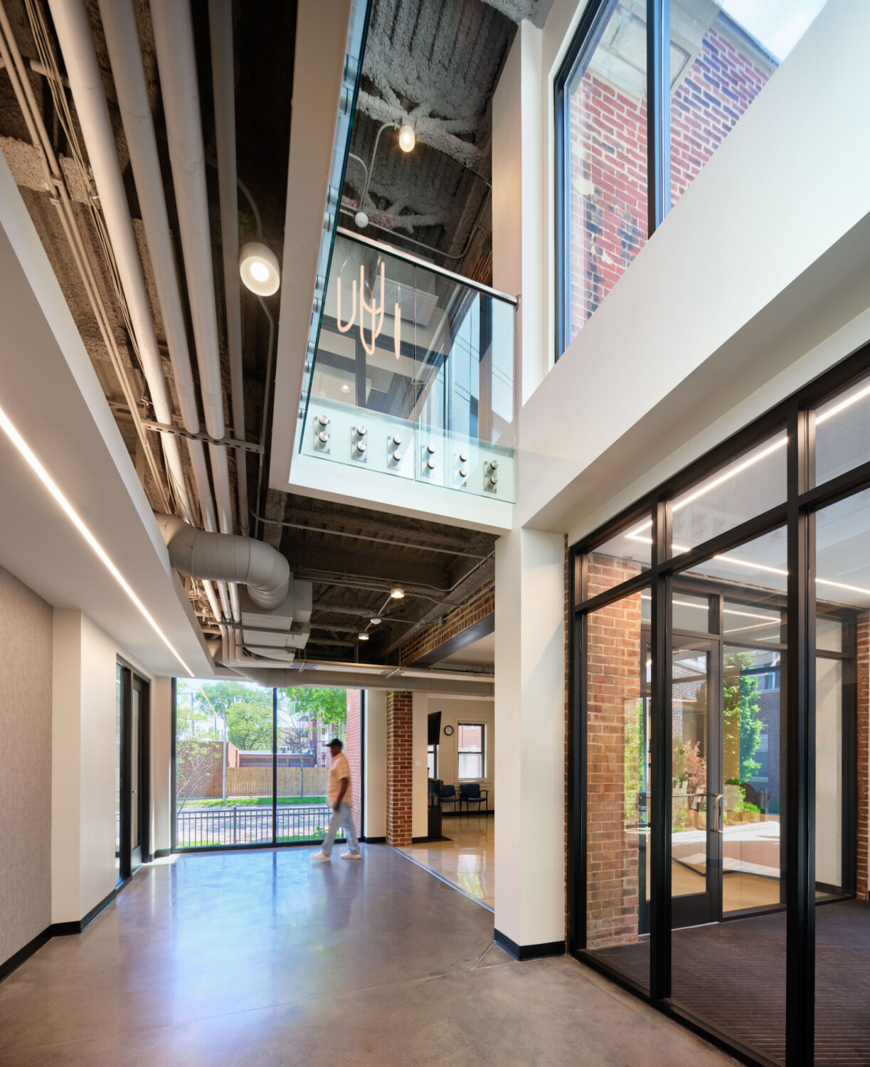 Double height atrium with glass railing and daylight at Thresholds Center for Mental Wellbeing South