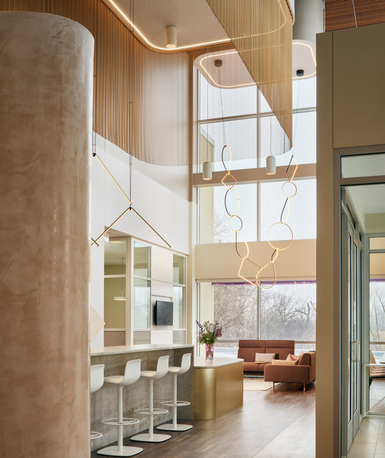 Cafe counter and double height window wall with sculptural pendants at Forward Space