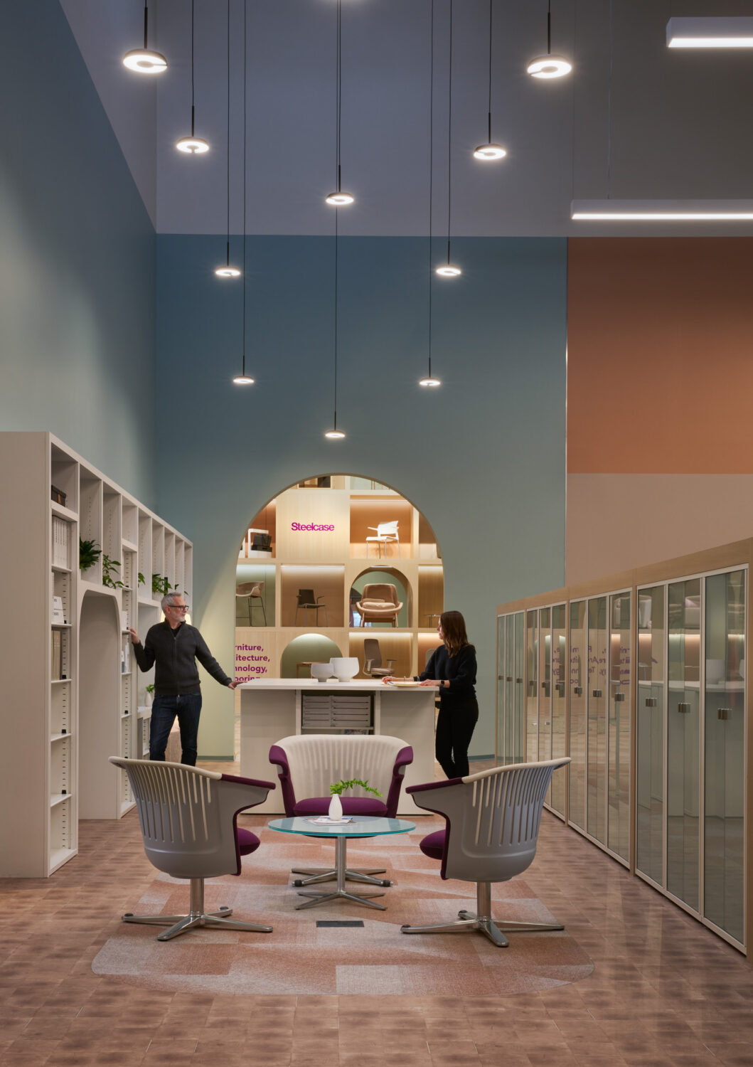 Library alcove with an arched niche, pendant lights and purple lounge chairs at Forward Space