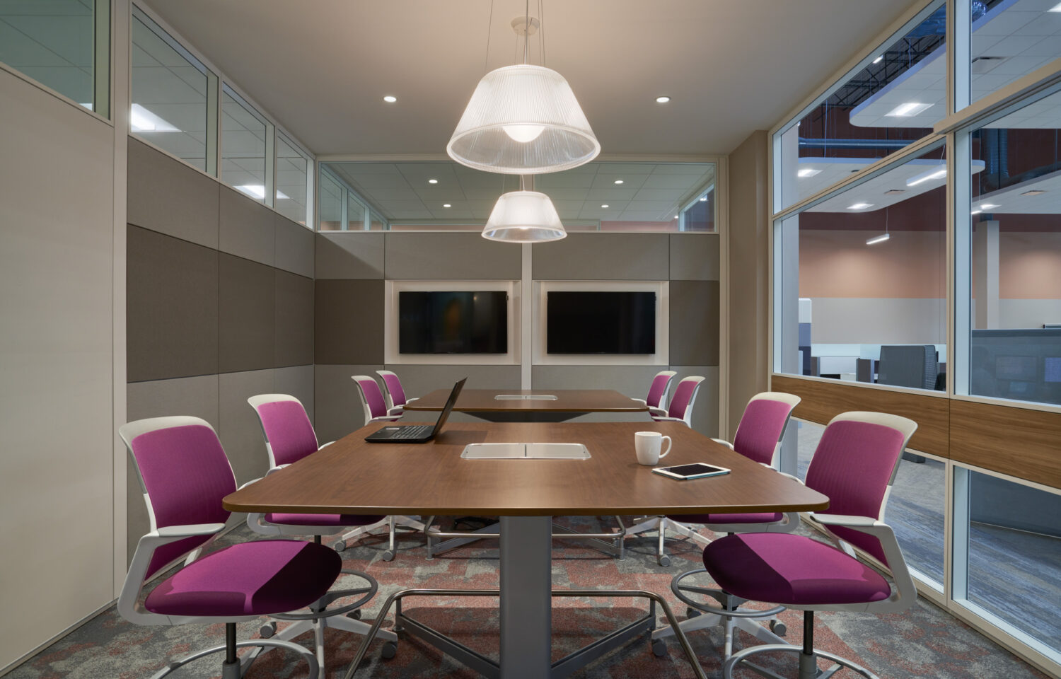 Conference room with magenta task chairs and dome pendants at Forward Space