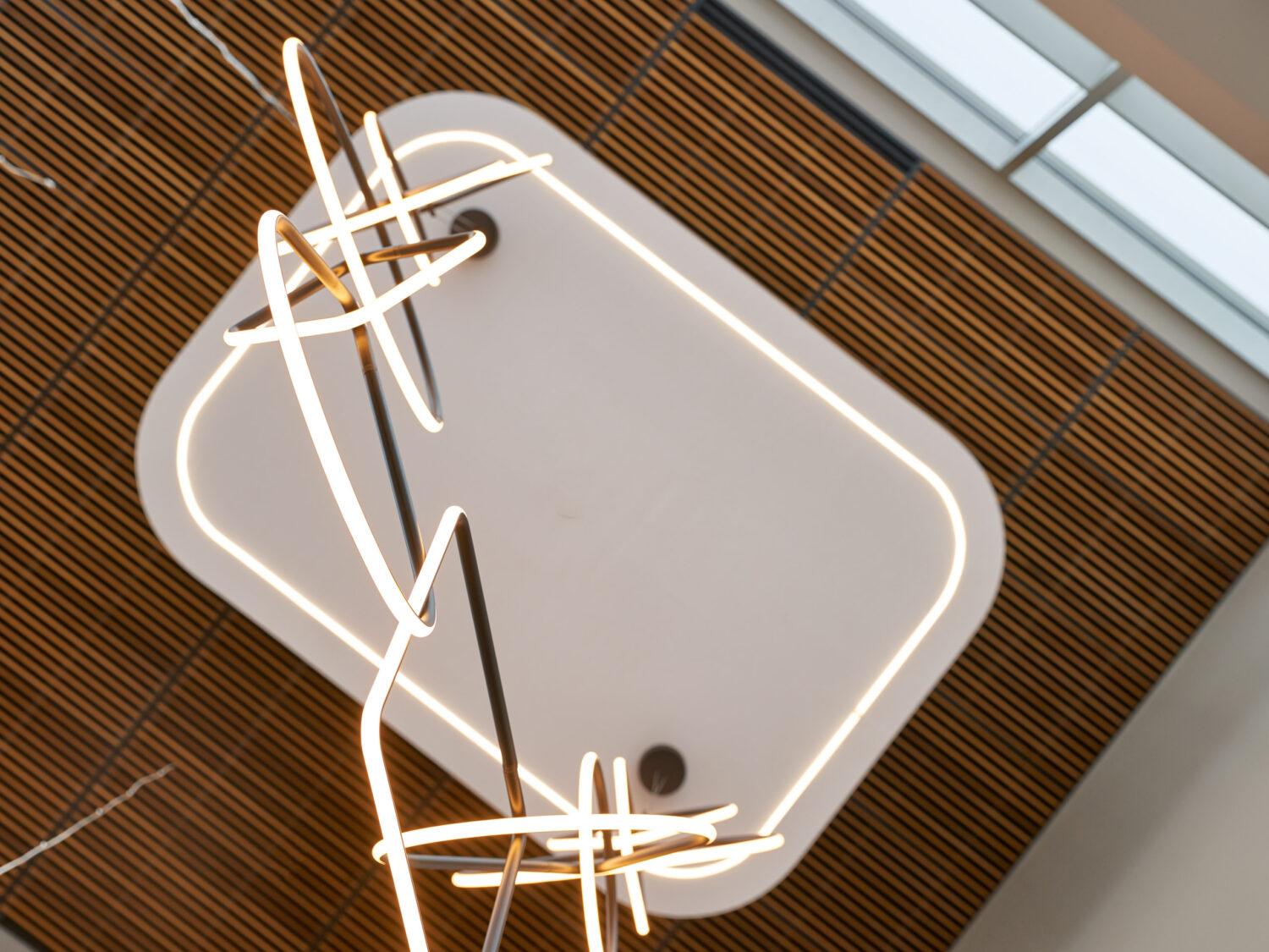 Close view of tangled light ribbons against a wood slat ceiling at Forward Space