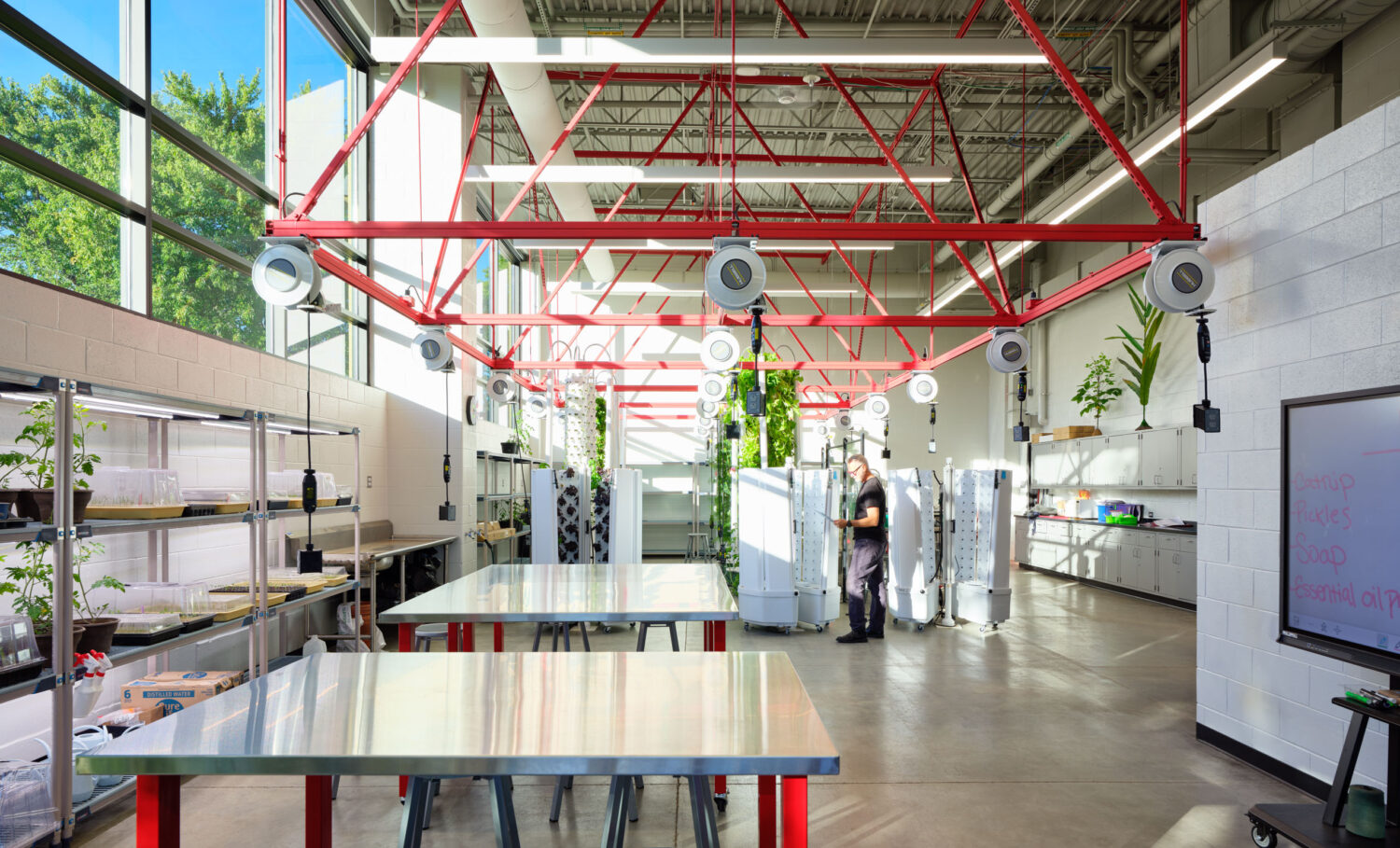 Bright lab with stainless worktables, large windows and red overhead piping at Rich Township High School