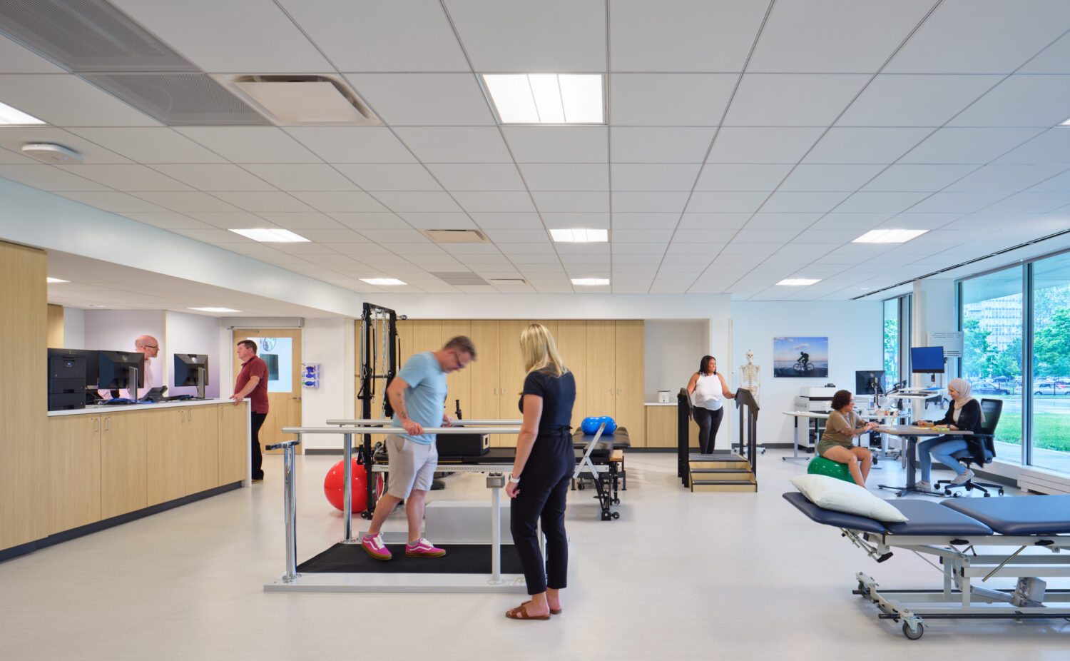 Rehabilitation gym with patients and therapists, Cook County Health Bronzeville Health Center by SmithGroup, Chicago, Illinois
