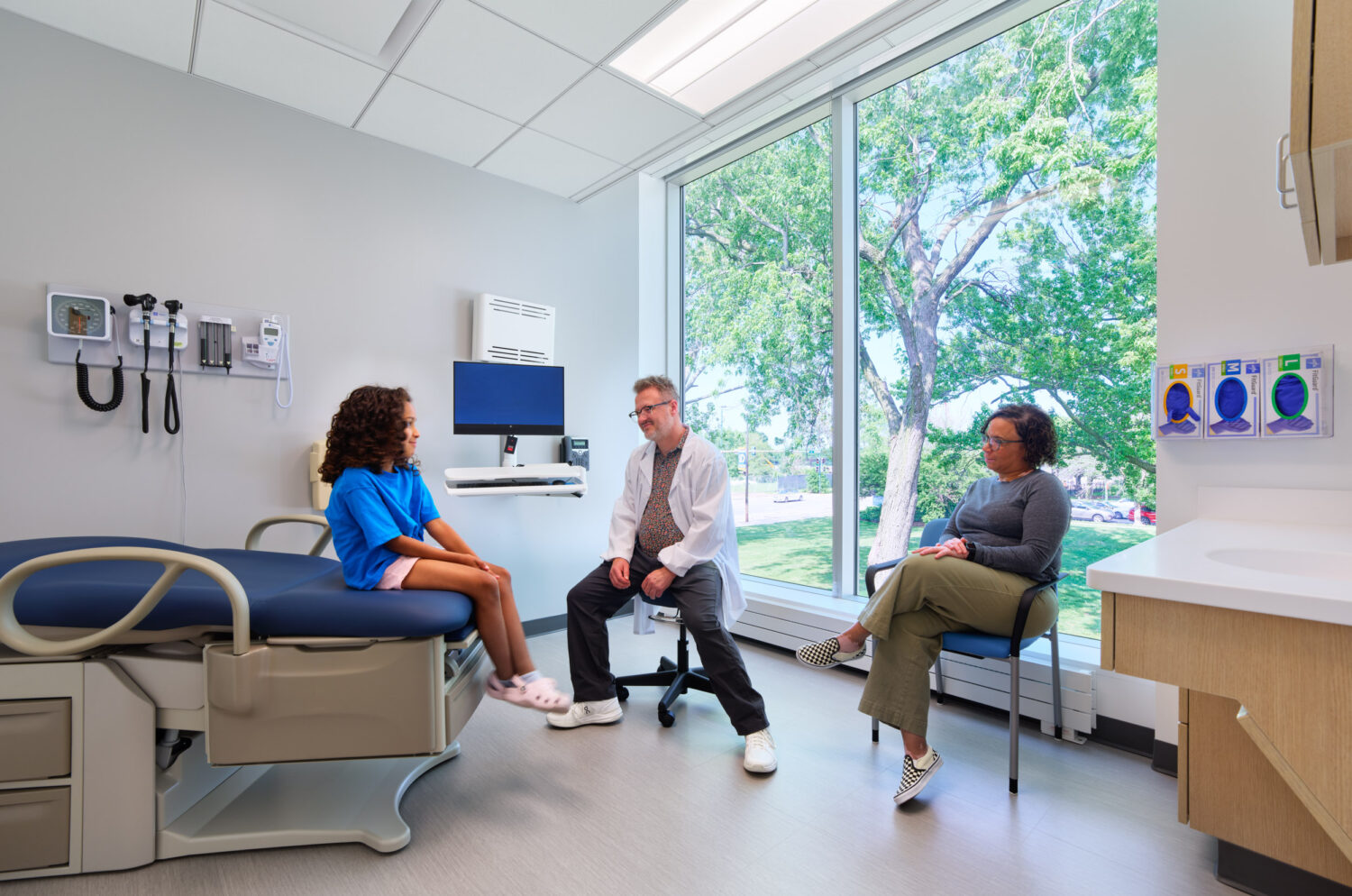 Exam room with a garden view through a large window, Cook County Health Bronzeville Health Center by SmithGroup, Chicago, Illinois