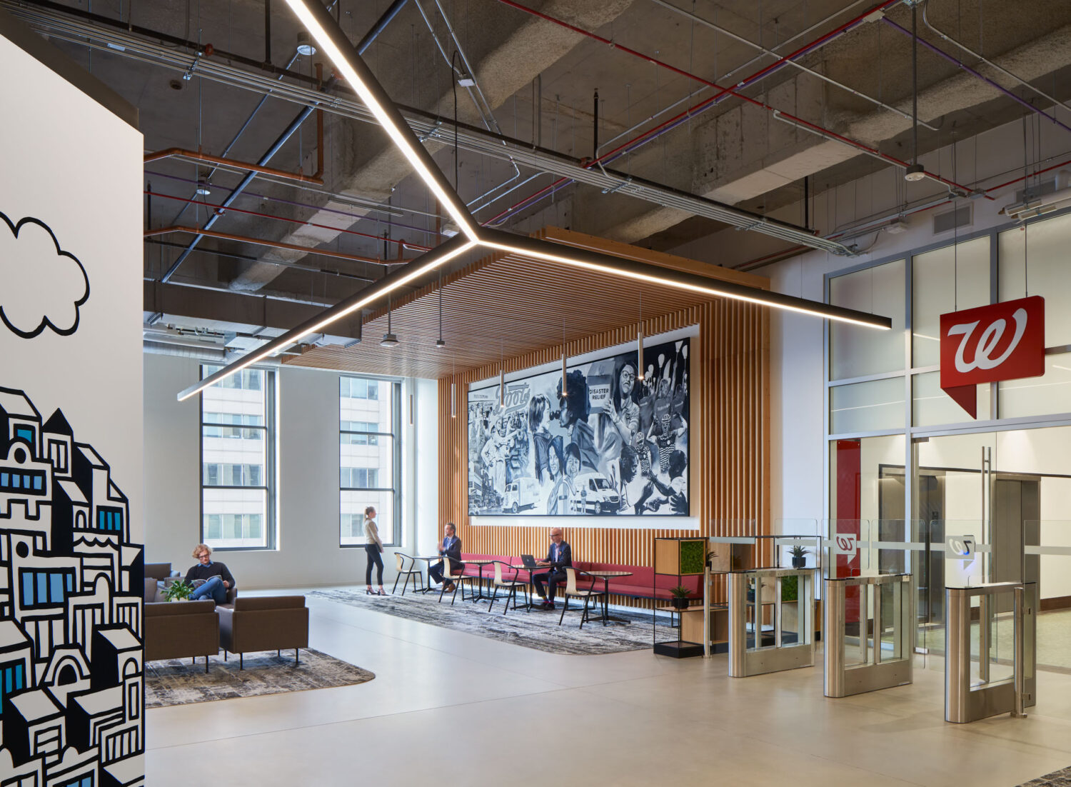 Reception with a red Walgreens sign, security gates and a black and white mural in the Old Post Office