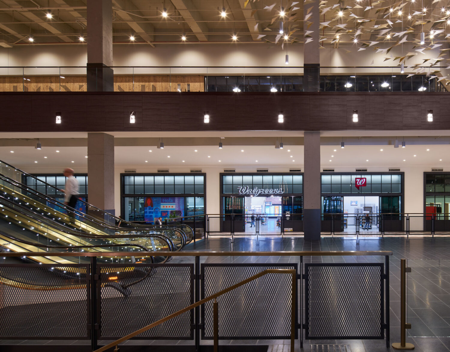 Escalators and Walgreens storefronts in the restored lobby of the Old Post Office