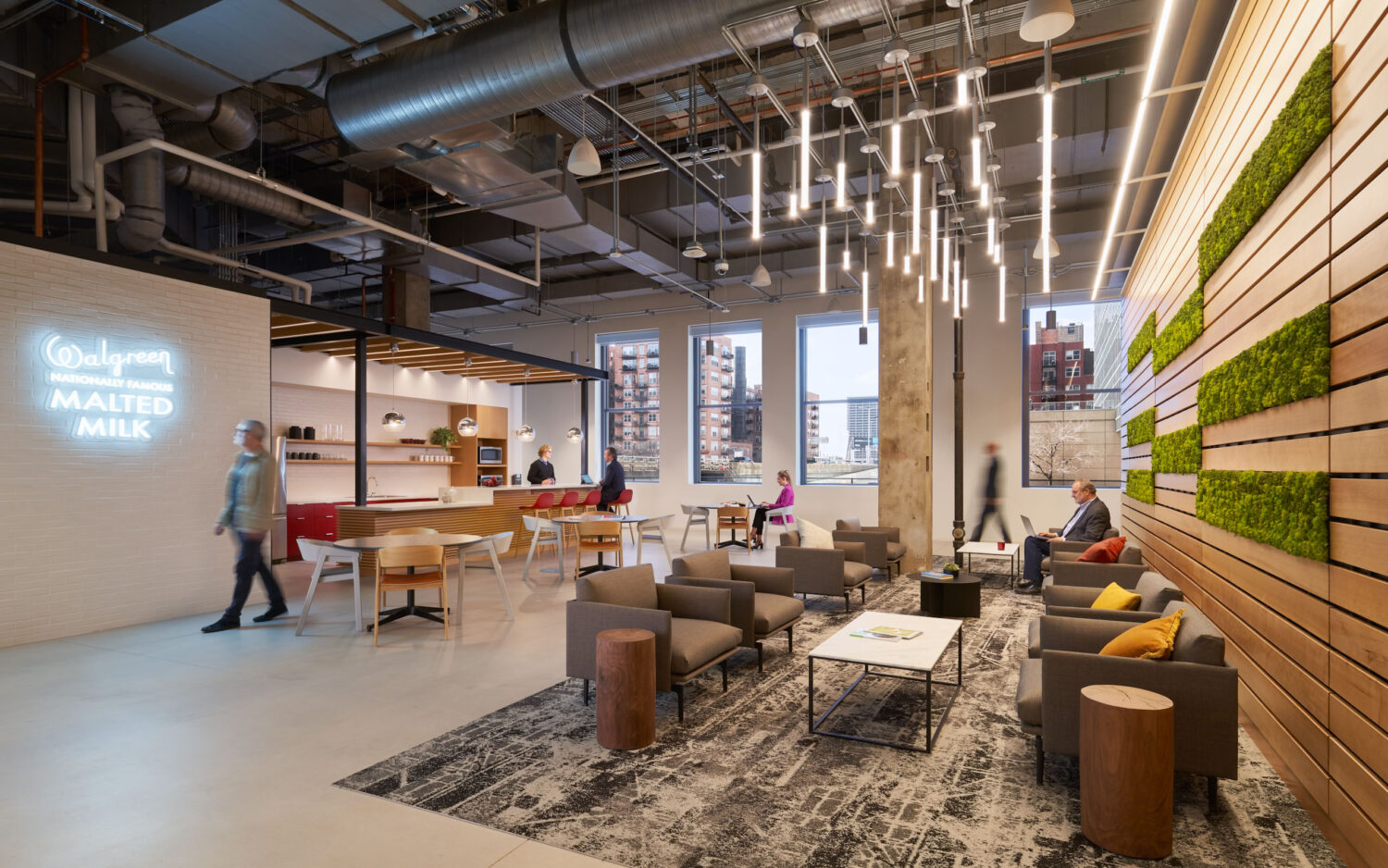 Lounge with a neon Malted Milk sign, moss wall and wood slats at Walgreens