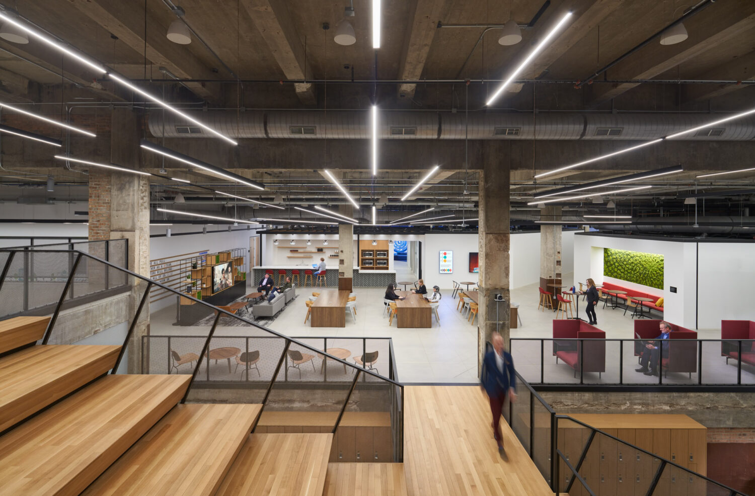 Wood bleacher stair overlooking an open work floor at Walgreens