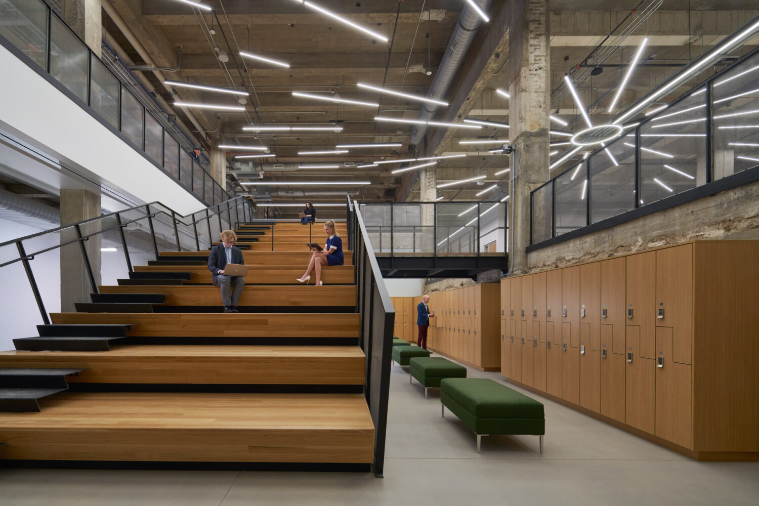 Wood stair seating beside a wall of lockers at Walgreens
