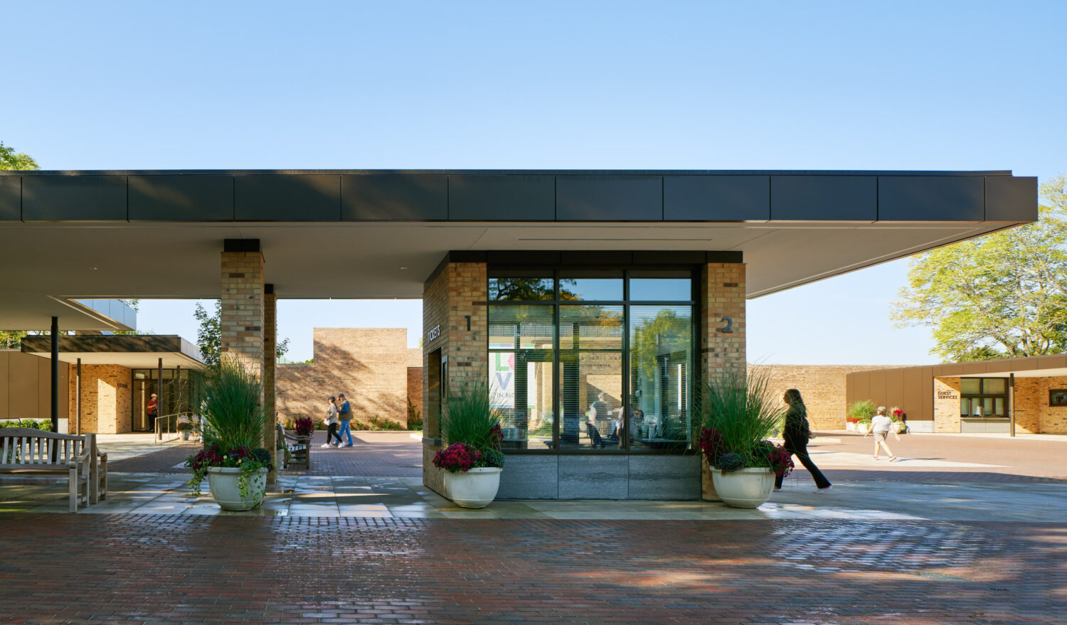 Information and ticketing pavilion at the Chicago Botanic Garden with brick piers and glass under a deep canopy