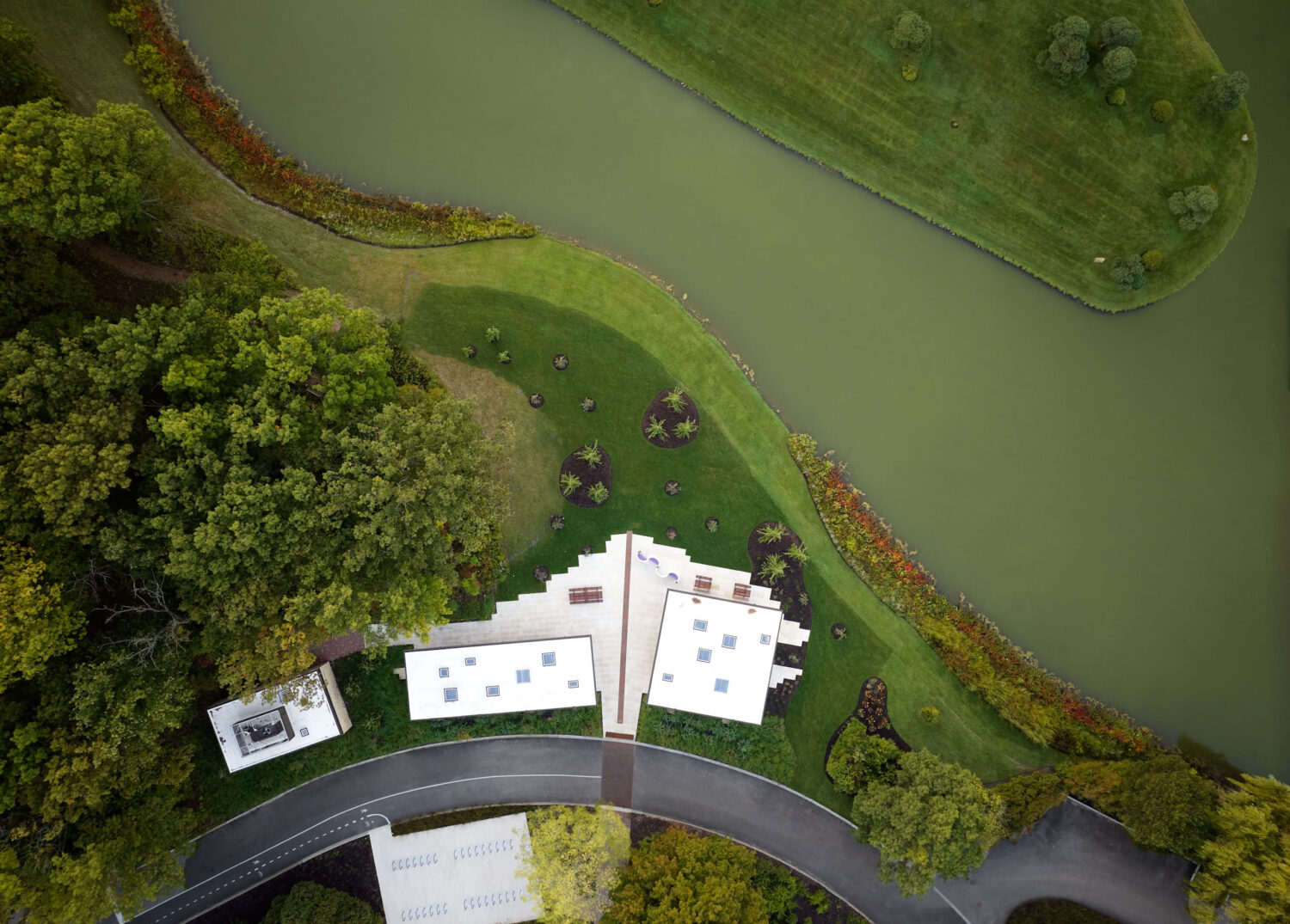 Overhead aerial of the Chicago Botanic Garden Picnic Glade pavilions between trees and the water